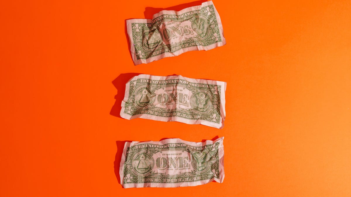 Three wrinkled dollar bills